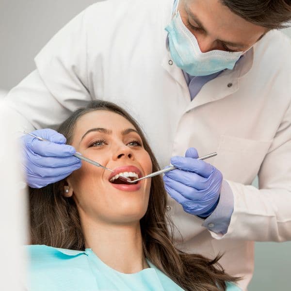 Dentist examining a patient's teeth during a checkup