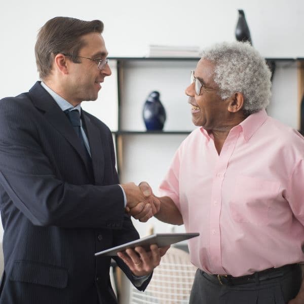 Advisor shaking hands with a client after discussing a life insurance policy