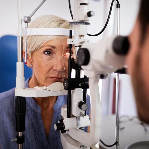 Patient having an eye exam with ophthalmic equipment